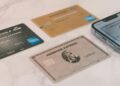 a group of credit cards sitting next to a cell phone