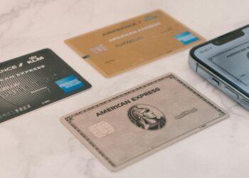 a group of credit cards sitting next to a cell phone