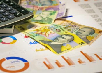 A calculator sitting on top of a pile of money
