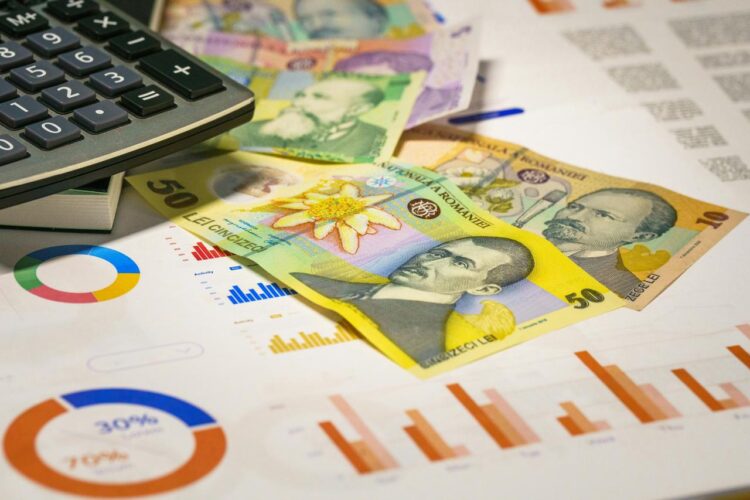A calculator sitting on top of a pile of money