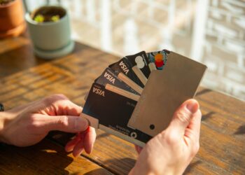 a person holding a credit card in their hand