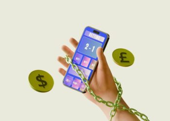 Chained hand holding smartphone calculator with dollar and pound coins