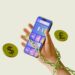 Chained hand holding smartphone calculator with dollar and pound coins