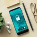 A smartphone displaying a security lock icon on a wooden desk with a succulent