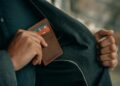 a man holding a wallet in his pocket