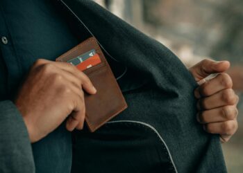 a man holding a wallet in his pocket