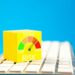 Yellow cube with risk meter on keyboard